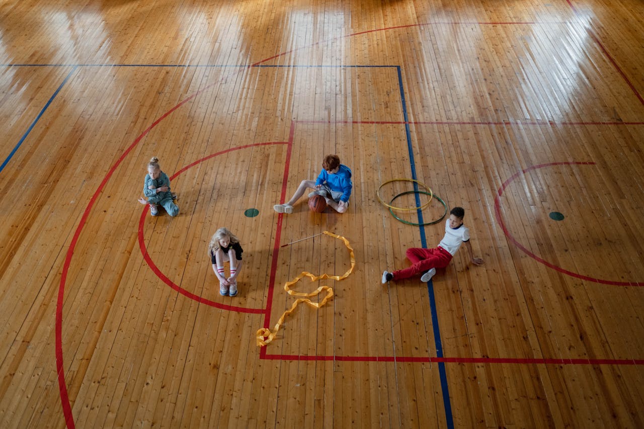 2 Children Playing on Basketball Court